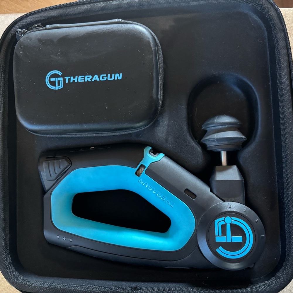 Theragun Massage Device with case and batteries.